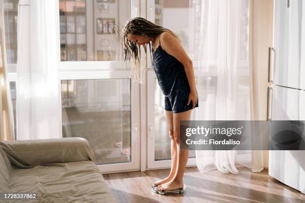 a middle-aged woman standing in the morning on the scales - bulimia nervosa - fotografias e filmes do acervo