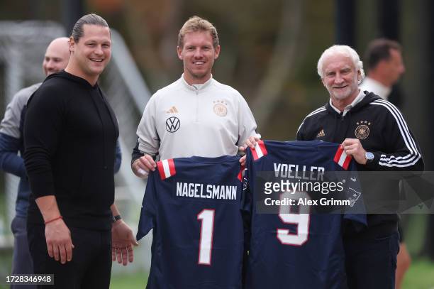 Former NFL player Markus Kuhn of Germany presents Julian Nagelsmann, head coach of Germany and Rudi Voller director of sport of Germany with NFL...