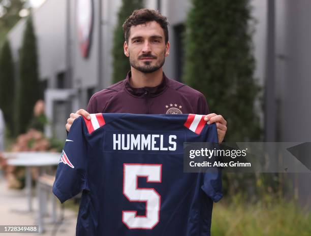 Mats Hummels of Germany holds a NFL shirt bearing his name during a training session of the German national football team on October 10, 2023 in...