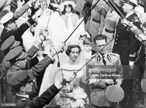 King Baudouin of Belgium and Queen Fabiola of Belgium leave their wedding ceremony under the swords of officers of the Belgian Army, Cathedral of St....