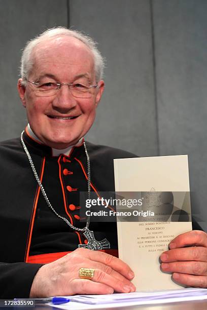 Canadian Cardinal Marc Ouellet, prefect of the Congregation for the Doctrine of the Faith holds a copy of Pope Francis' first encyclical, entitled...