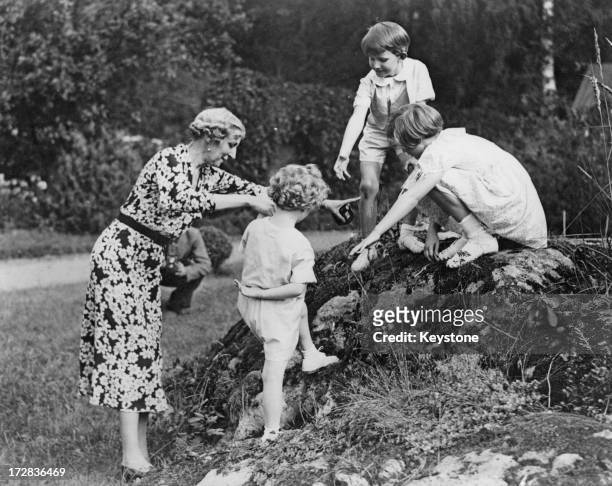 Prince Baudouin of Belgium and Princess Josephine Charlotte of Belgium help their brother, Prince Albert of Belgium, later King Albert II of Belgium...