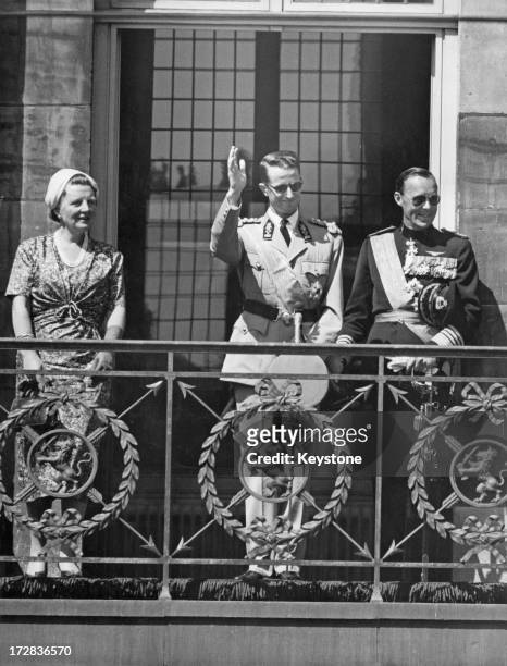 King Baudouin of Belgium on a State Visit to Holland, stands with Queen Juliana of the Netherlands and Prince Bernhard of the Netherlands to...