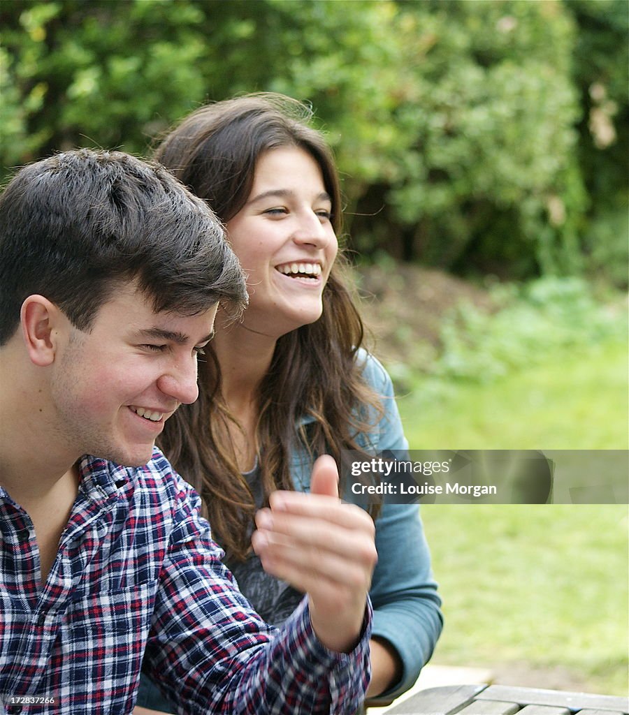 Teenage boy and girl laughing