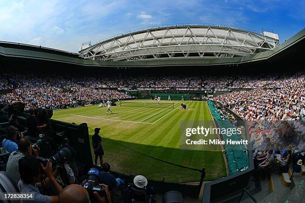 General view of Centre Court as Juan Martin Del Potro of Argentina plays a shot through his legs during the Gentlemen's Singles semi-final match...