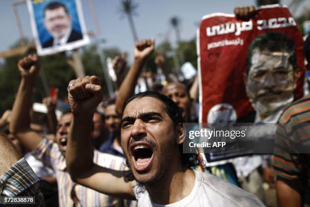 An Egyptian supporter of the Muslim Brotherhood and ousted president Mohamed Morsi shouts religious and political slogans during a protest near Cairo...