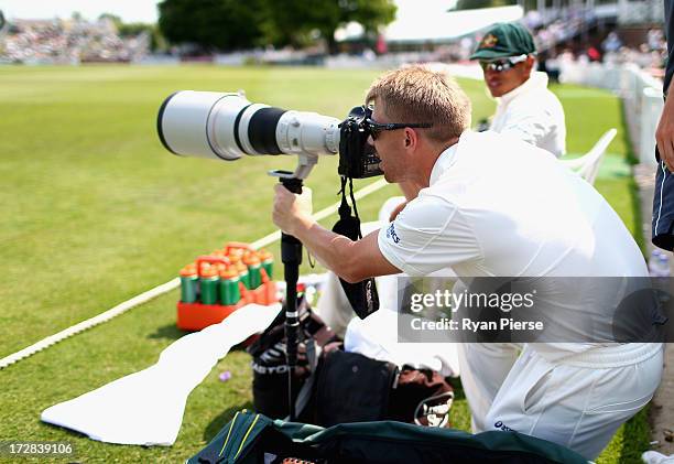 David Warner of Australia takes photos from the boundary during day three of the Tour Match between Worcestershire and Australia at New Road on July...