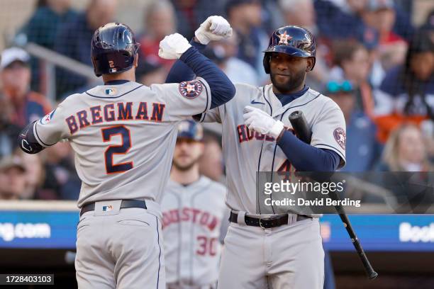 Alex Bregman and Yordan Alvarez of the Houston Astros celebrate after Bregman hit a home run in the fifth inning against the Minnesota Twins during...