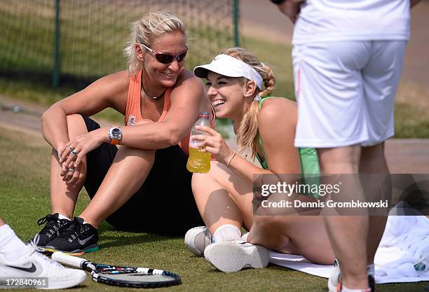 Sabine Lisicki of Germany laughs as she talks with Barbara Rittner, captain of the German Fed Cup team during a practice session on day eleven of the...