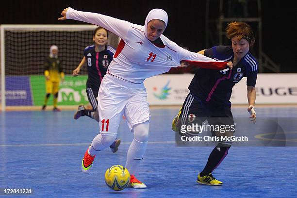 Natsumi Koide of Japan contests the ball with Ardallani Niloofar of Iran during the Women's Futsal Gold Medal match at Songdo Global University...