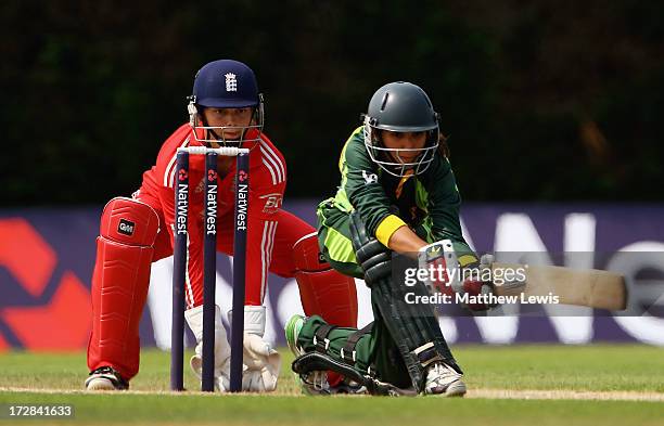 Bismah Maroof of Pakistan sweeps the ball, as Amy Jones of England looks on during the 2nd NatWest Women's International T20 match between England...