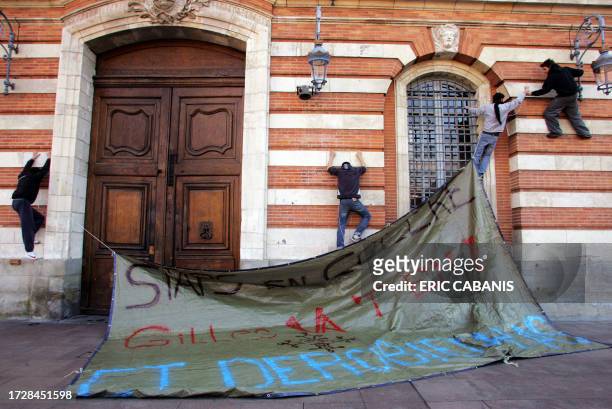 Physical education students display a banner reading "Staps angry, Gilles go away and don't come back" on the Toulouse townhall facade as they...