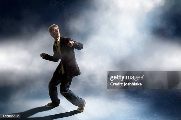 man in a suit looking up in a ready-to-run stance - trapped stock pictures, royalty-free photos & images