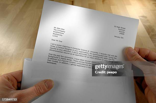 pov of hands holding job application letter - answering stock pictures, royalty-free photos & images