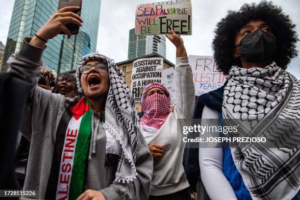 People hold signs during a rally in support of Palestinians at Copley Square in Boston, Massachusetts on October 16, 2023. Israel warned October 16,...