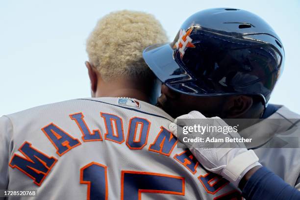 Yordan Alvarez of the Houston Astros kisses Martín Maldonado after Alvarez hit a home run in the ninth inning against the Minnesota Twins during Game...