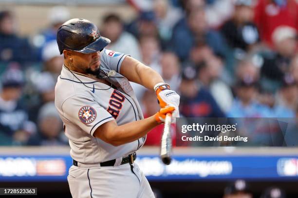 José Abreu of the Houston Astros hits a home run in the ninth inning against the Minnesota Twins during Game Three of the Division Series at Target...