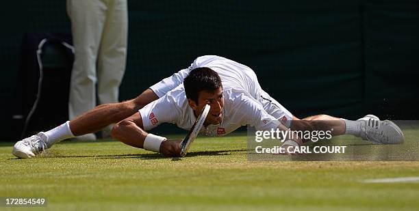 Serbia's Novak Djokovic slides as he returns against Argentina's Juan Martin Del Potro during their men's singles semi-final match on day eleven of...