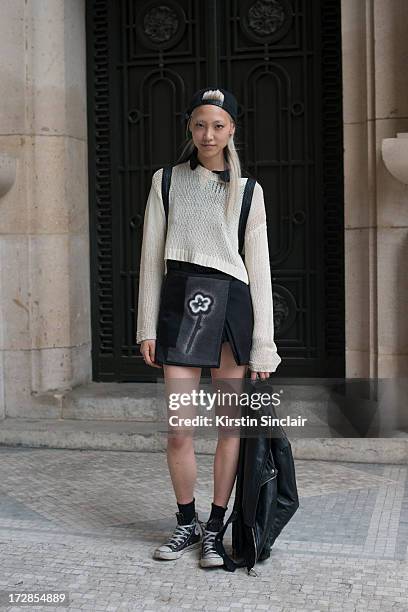 Model Soo Joo Park wears Opening Ceremony top, Prada skirt, Converse trainers and a Chanel bag on day 2 of Paris Collections: Womens Haute Couture on...