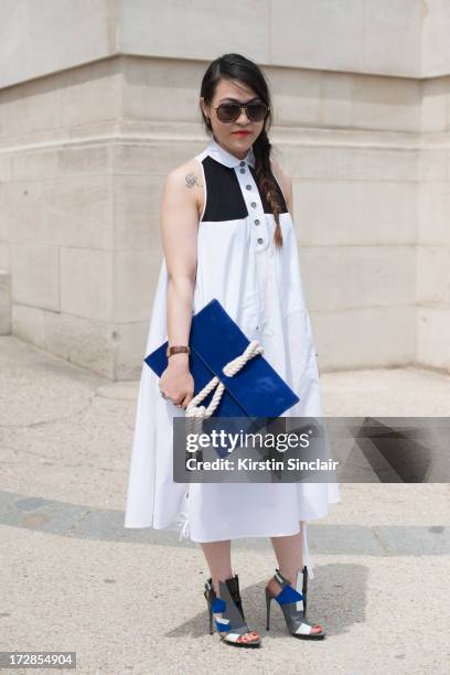 Fashion Editor for Milk Tawain Titi Chen wears a kenzo dress, vintage sunglasses, Balenciaga shoes and a bag from a small boutique on day 2 of Paris...