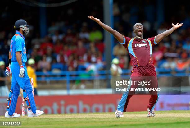 West Indies cricketer Kemar Roach unsuccessfully appeals for a dismissal against Indian cricket team captain Virat Kohli during the fourth match of...