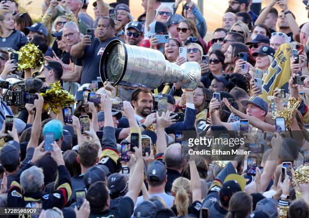 Mark Stone of the Vegas Golden Knights carries the Stanley Cup through fans as he arrives at the team's home opener against the Seattle Kraken at...