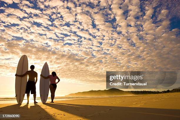 sunrise surfers - surfer by the beach australia stock pictures, royalty-free photos & images