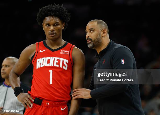 Head coach Ime Udoka of the Houston Rockets confers with Amen Thompson during the game against the San Antonio Spurs at Frost Bank Center on October...