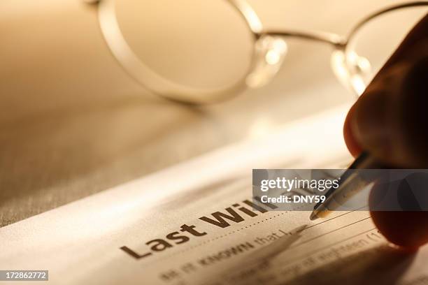 man signing last will and testament - writing a will stock pictures, royalty-free photos & images