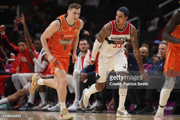 Kyle Kuzma of the Washington Wizards celebrates a three-pointer in front of Jonah Antonio of the Cairns Taipans during the first half of a preseason...