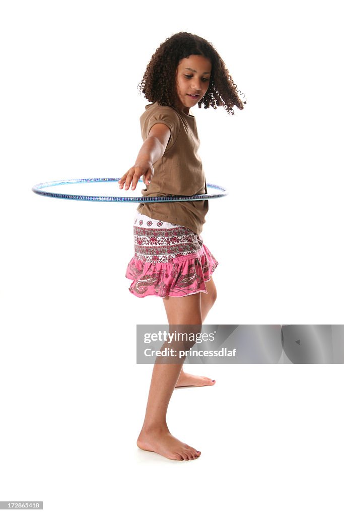 Isolated tween girl hula hooping on white background