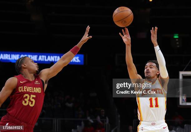 Trae Young of the Atlanta Hawks shoots a three-point basket against Isaac Okoro of the Cleveland Cavaliers during the first quarter at State Farm...