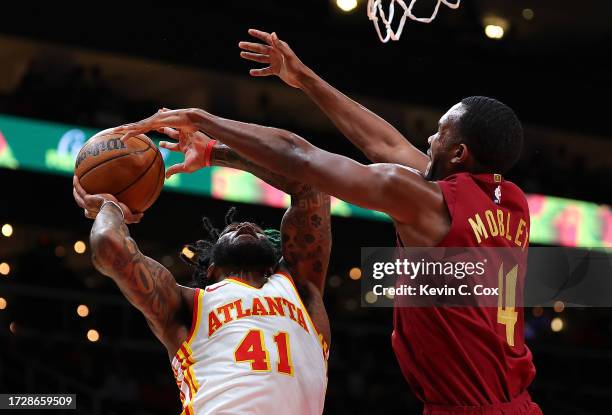 Evan Mobley of the Cleveland Cavaliers defends against Saddiq Bey of the Atlanta Hawks during the first quarter at State Farm Arena on October 10,...