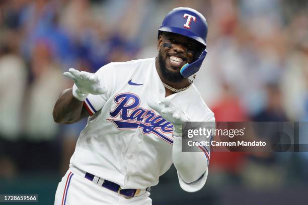 Adolis Garcia of the Texas Rangers celebrates after hitting a three-run home run against the Baltimore Orioles during the second inning in Game Three...