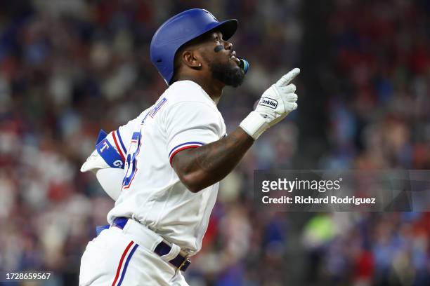 Adolis Garcia of the Texas Rangers celebrates after hitting a three-run home run against the Baltimore Orioles during the second inning in Game Three...