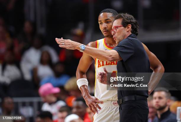 Head coach Quin Snyder and Kobe Bufkin of the Atlanta Hawks converse against the Cleveland Cavaliers during the second quarter at State Farm Arena on...