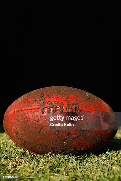 muddy afl ball - australian rules football ball stock pictures, royalty-free photos & images