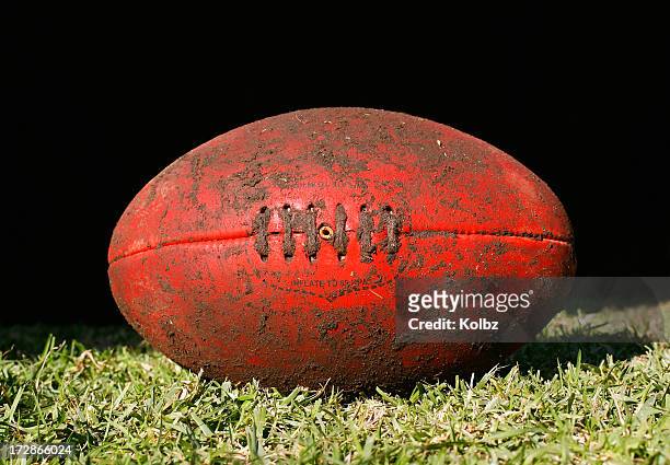 muddy afl ball - australian rules football ball stock pictures, royalty-free photos & images