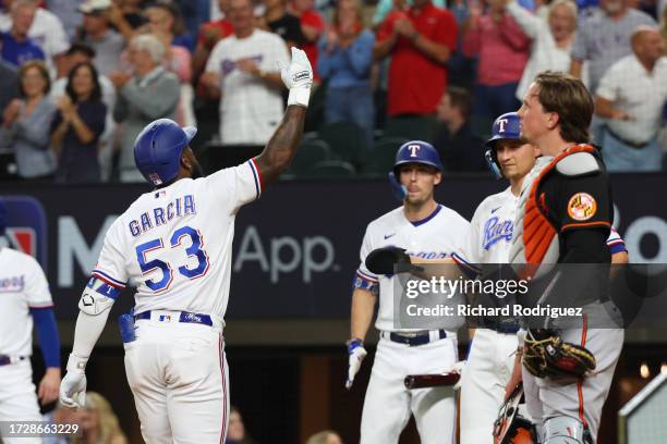 Adolis Garcia of the Texas Rangers celebrates after hitting a three-run home run against the Baltimore Orioles during the second inning in Game Three...