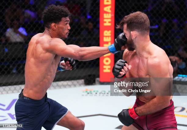Jair Farias of Brazil punches Connor Matthews in a featherweight fight during Dana White's Contender Series season seven, week ten at UFC APEX on...