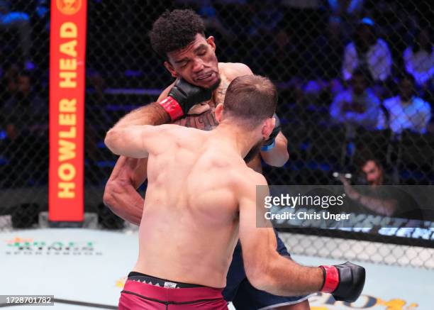 Connor Matthews punches Jair Farias of Brazil in a featherweight fight during Dana White's Contender Series season seven, week ten at UFC APEX on...