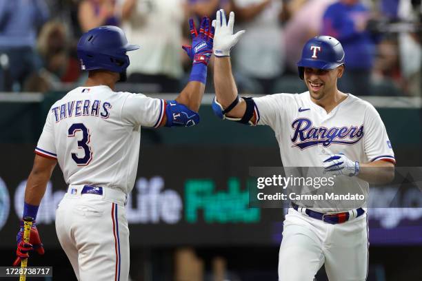 Nathaniel Lowe of the Texas Rangers celebrates after his solo home run against the Baltimore Orioles with Leody Taveras during the sixth inning in...