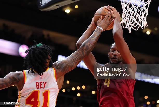 Evan Mobley of the Cleveland Cavaliers grabs a rebound against Saddiq Bey of the Atlanta Hawks during the second quarter at State Farm Arena on...