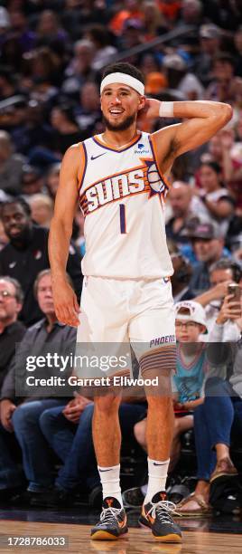 Devin Booker of the Phoenix Suns smiles during the game against the Portland Trail Blazers on October 16, 2023 at Footprint Center in Phoenix,...