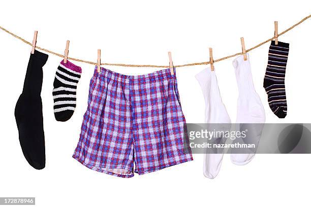 a picture of clothes hanging from a clothes line - sock stock pictures, royalty-free photos & images
