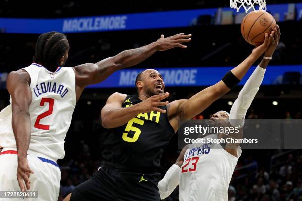 Talen Horton-Tucker of the Utah Jazz shoots against Kawhi Leonard and Robert Covington of the LA Clippers during the second quarter of the Rain City...