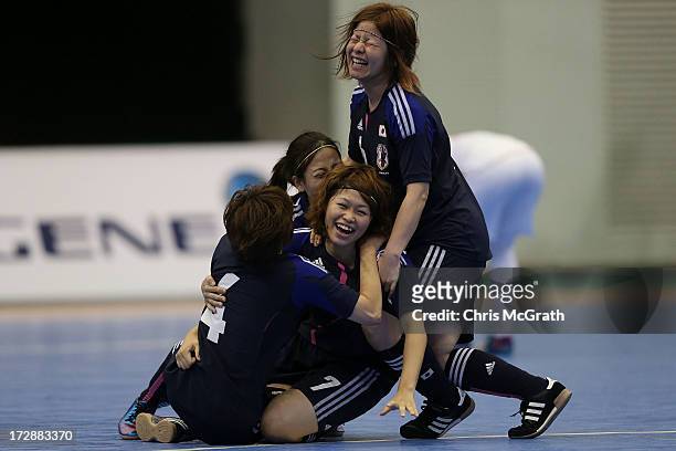 Chikage Kichibayashi of Japan is congratulated by team mates after scoring a goal against Iran during the Women's Futsal Gold Medal match at Songdo...