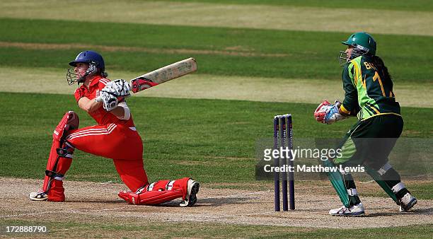 Susie Rowe of England hits the ball towards the boundary, as Batool Fatima of Pakistan looks on during the 2nd NatWest Women's International T20...