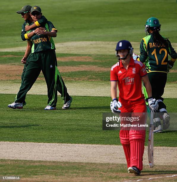 Sana Mir of Pakistan is congratulated by team mates, after catching Amy Jones of England during the 2nd NatWest Women's International T20 match...