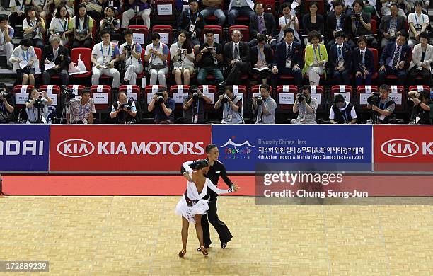 Ayan Zhumatayev and partner Liya Kazbekova of Kazakhstan compete in the Dancesport- Latin Cha Cha Cha Final at Samsan World Gymnasium during day...